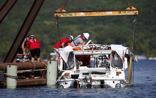The duck boat that sank in Table Rock Lake in Branson, Mo., is raised Monday, July 23, 2018. The boat went down Thursday evening after a thunderstorm generated near-hurricane strength winds. (Nathan Papes/The Springfield News-Leader via AP)