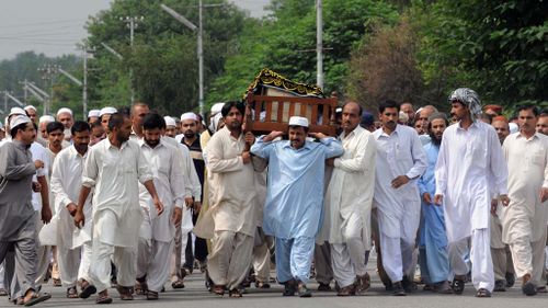 Pakistani mourners carry a coffin of a suicide blast victim during a funeral ceremony in Wah. (Getty)