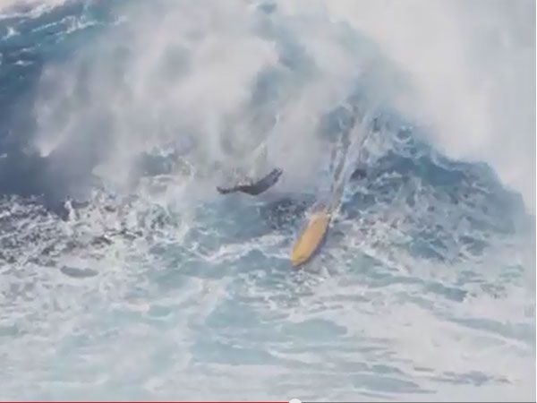 Surfer cartwheels down monster wave