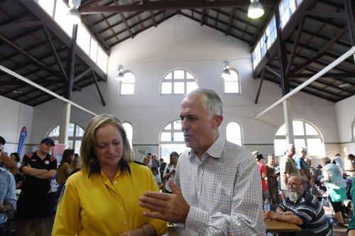 The PM speaking to Bundendore RFS' Sharon Kelly about the relief effort. (AAP)