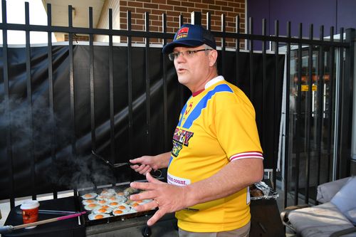 Prime Minister Scott Morrison helps cook breakfast for students from the Clontarf Academy at Endeavour Sports High School in Sydney