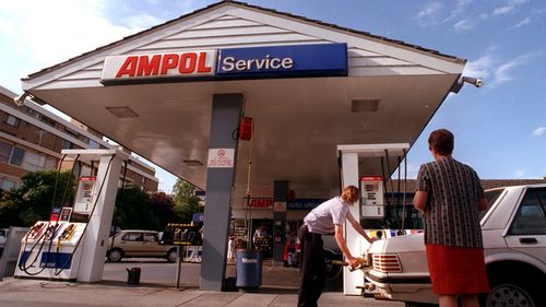 A man fills up his car in 1998 at the Ampol petrol station in Toorak, Melbourne.