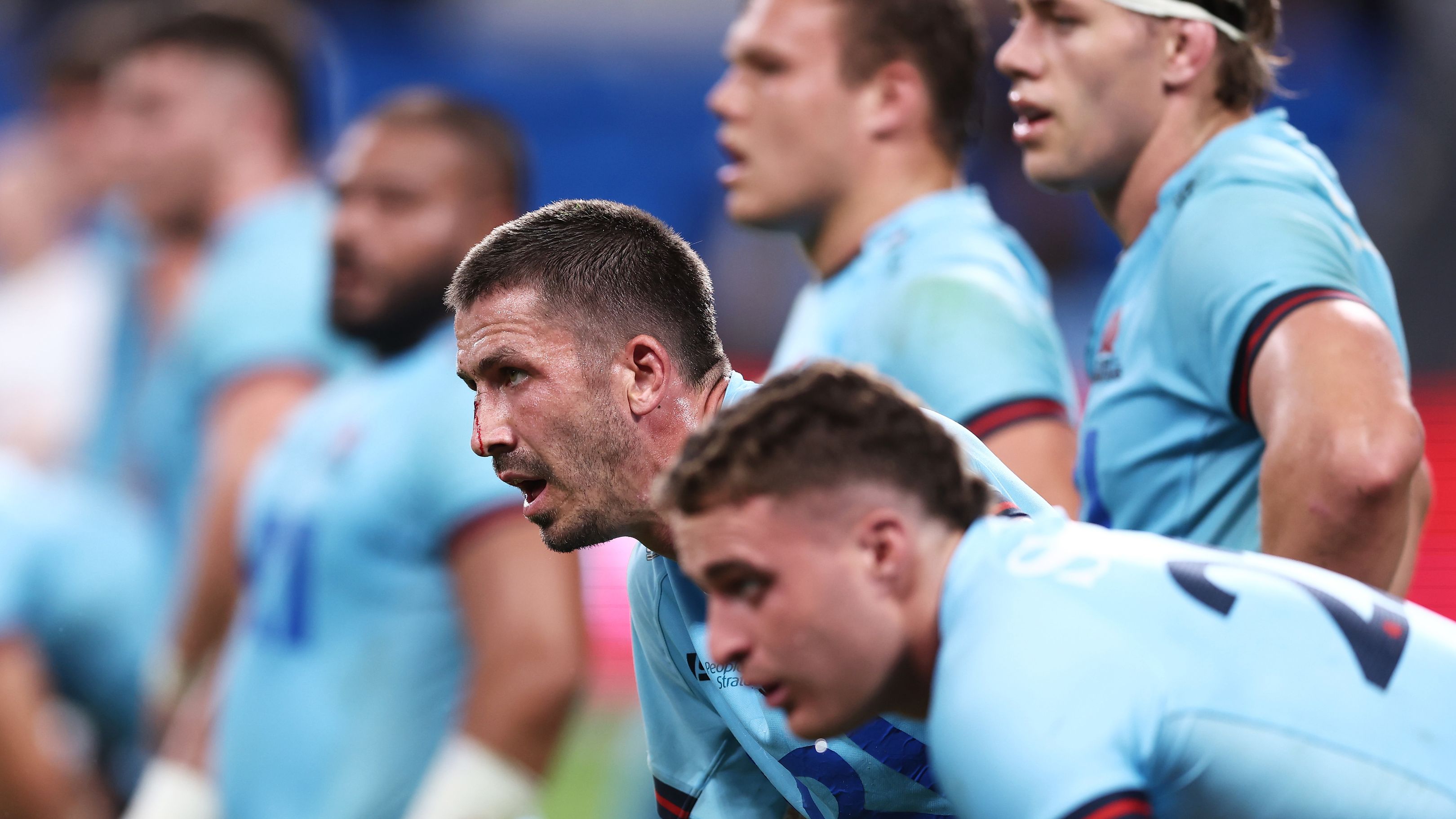 Jake Gordon of the Waratahs and team mates look dejected after the final Chiefs try during.