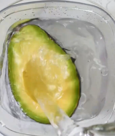 Perfectly ripe avocado cut in half water