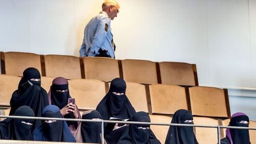 Women wearing the islamic veil niqab sit in the audience seats of the Danish Parliament. (Photo: AP).