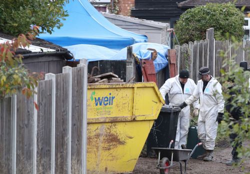 Police forensic experts search for clues in the garden of a house linked to the prime suspect in the Lamplugh case.