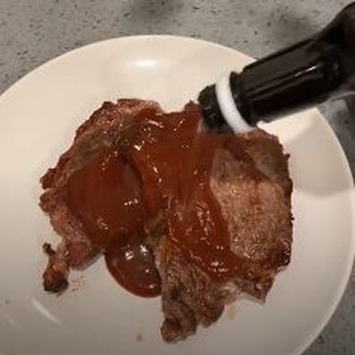 Woman cooks steak in a toaster