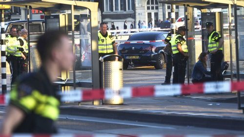 Police officers investigate at the Amsterdam Centraal station in Amsterdam, Netherlands. (AAP)