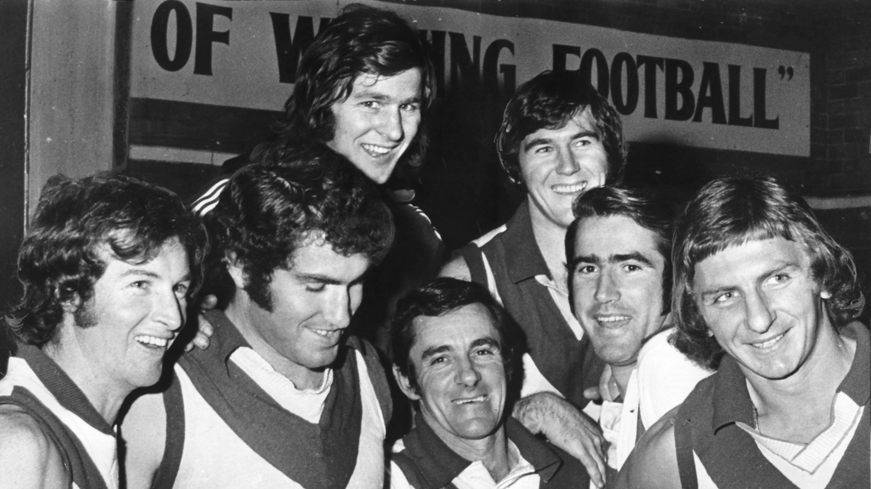 South Melbourne Football Club (Later Sydney Swans) - VFL - Victorian Football League (Later AFL). Right: Congratulating Graeme John (second from right) on his reappointment are from left: Peter Bedford, Ricky Quade, Norm Goss, Reserves coach Ken McCormack, David McLeish and Jim Prentice. File
