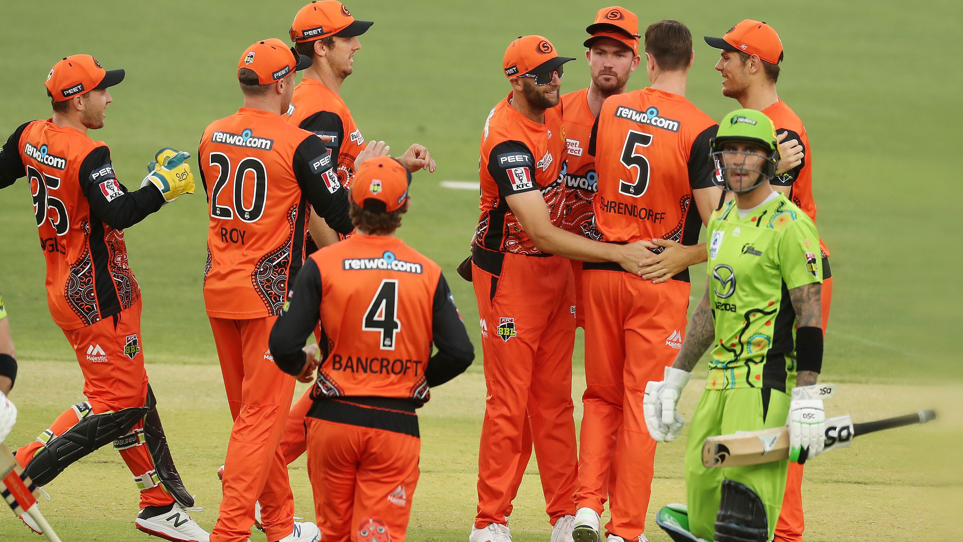 Andrew Tye of the Scorchers  celebrates after taking a catch to dismiss Callum Ferguson of the Thunder.