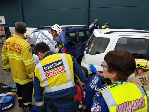 An elderly woman and her daughter were seriously injured when a car reversed over them in a Bunnings carpark late this morning.