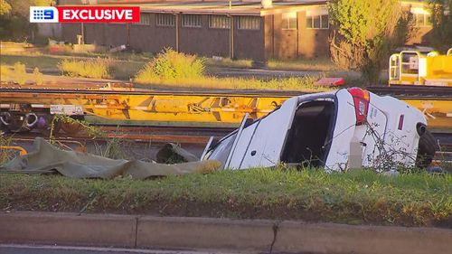 A car has rolled down an embankment after a crash in Greenacre, in Sydney's South West.