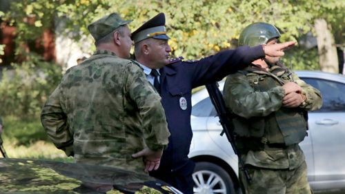 Military and police near the site of an attack at a vocational school in Crimea, Russia.