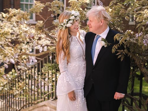 British Prime Minister Boris Johnson poses with his wife Carrie Johnson in the garden of 10 Downing Street following their wedding at Westminster Cathedral, May 29, 2021