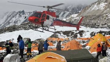 A helicopter prepares to land at the Mount Everest base camp. (Getty)