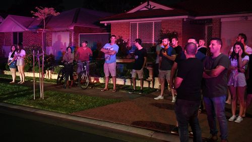 Local residents watch flames close to homes in Corryton Court, Wattle Grove. (AAP)