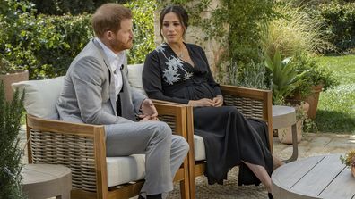 This image provided by Harpo Productions shows Prince Harry, from left, and Meghan, The Duchess of Sussex, in conversation with Oprah Winfrey. (Joe Pugliese/Harpo Productions via AP)