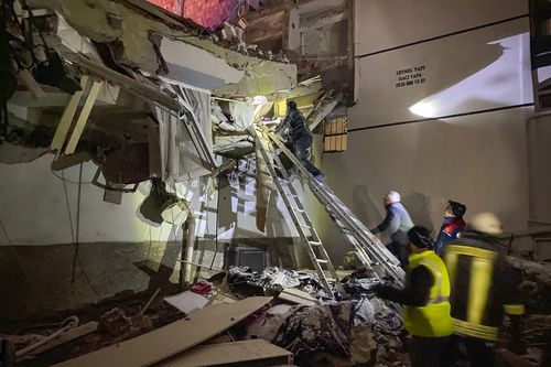 Rescue teams try to reach trapped residents inside collapsed buildings in Adana, Turkey, Monday, Feb. 6, 2023 