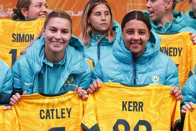MELBOURNE, AUSTRALIA - JULY 11: Steph Catley of the Matildas (L) and Sam Kerr of the Matildas pose with their jerseys during the Australia Matildas World Cup squad public presentation at Federation Square on July 11, 2023 in Melbourne, Australia. (Photo by Daniel Pockett/Getty Images)