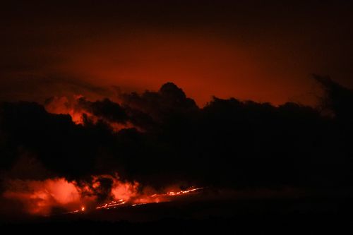 Lava flows from the Mauna Loa volcano Friday, December 2, 2022, near Hilo, Hawaii.