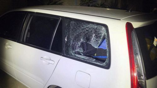 The window of a car in the driveway was smashed.