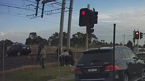 Vision of a car on the Melbourne train trucks being hit by a train