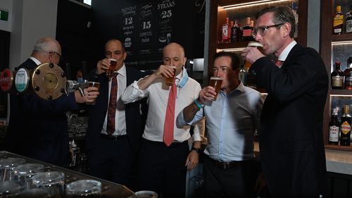 A photo opportunity for NSW Premier Dominic Perrottet (right) who sipped a frothy with NSW Deputy Premier Paul Toole (2nd from right) and NSW Treasurer Matt Kean at the newly opened Watsons Pub in Moore Park.