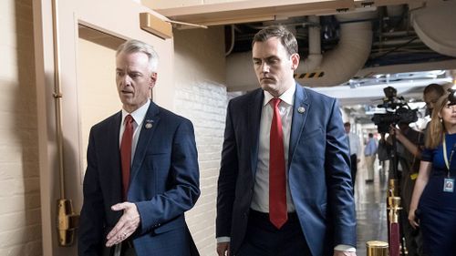 Rep Steve Russell, R-Okla and Rep Mike Gallagher, R-Wis, walk to a closed-door meeting with House Republicans seeking more information about compromise legislation on immigration. Picture: AP