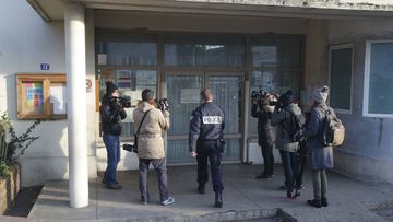 A police officer enters a pre-school in the Paris suburb Aubervilliers. (AAP)