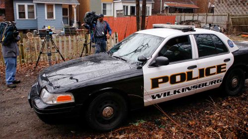 Wilkinsburg police drive past the scene. (AAP)