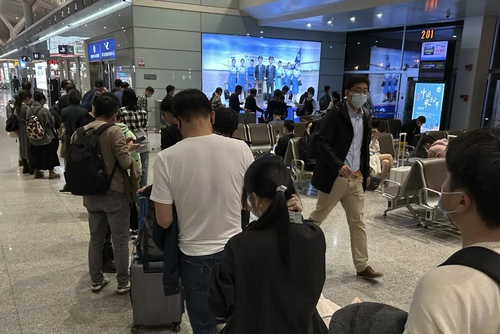 Passengers prepare to board a flight at the airport in north-central China's Jiangxi province on Nov. 1, 2022. The Chinese government said Tuesday, Dec. 27 it will start issuing new passports as it dismantles anti-virus travel barriers, setting up a potential flood of millions of tourists out of China for next month's Lunar New Year holiday.