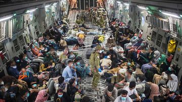 Australian citizens and Afghan visa holders aboard a C-17A Globemaster III leaving Kabul.