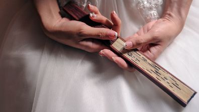 Bride holding paper fan