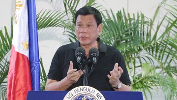Philippines President Rodrigo Duterte delivers a speech at the Davao international airport terminal building early on September 30, 2016, shortly after arriving from an official visit to Vietnam. (AFP)