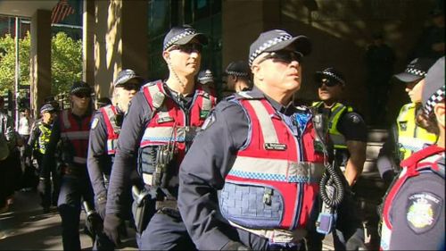 Scores of police lined the street. (9NEWS)