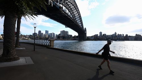 A person exercising under the Sydney Harbour Bridge.