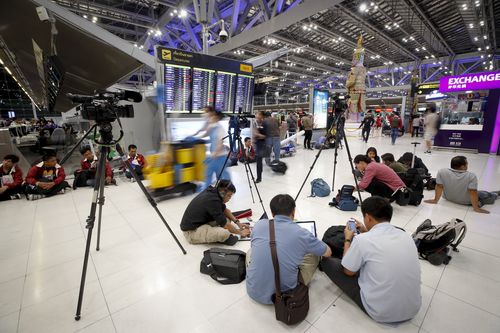 Photographers wait at Bangkok airport to catch a glimpse of Hakeem.