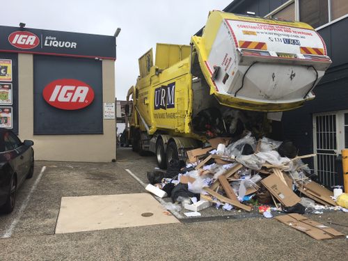 A shopper told 9News.com.au the truck struggled to correctly lift bins before the mishap. (Australia Media)