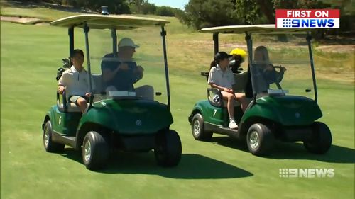 Woods zoomed around the course with Hugo and Jemima on golf buggies today.