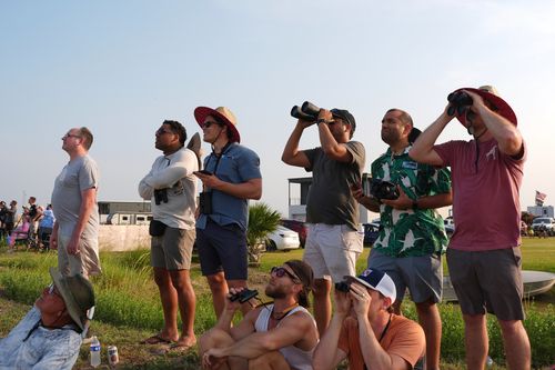 People watch as SpaceX's mega rocket Starship makes a test flight from Starbase, Texas, Tuesday, May 27, 2025. (AP Photo/Eric Gay)