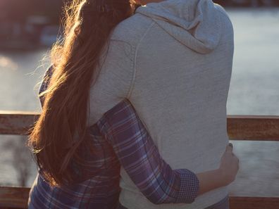 Young couple watching sunset.