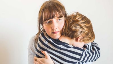 Mum hugging and comforting her son.