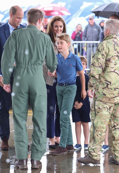 FAIRFORD, ENGLAND - JULY 14:  Prince George of Wales shakes hands during their visit to the Air Tattoo at RAF Fairford with  Prince William, Prince of Wales and Catherine, Princess of Wales on July 14, 2023 in Fairford, England. The Prince and Princess of Wales have a strong relationship with the RAF, with the Prince having served with the Search and Rescue Force for over three years, based at RAF Valley in Anglesey. The Prince is Honorary Air Commodore of RAF Coningsby and The Princess is Honor