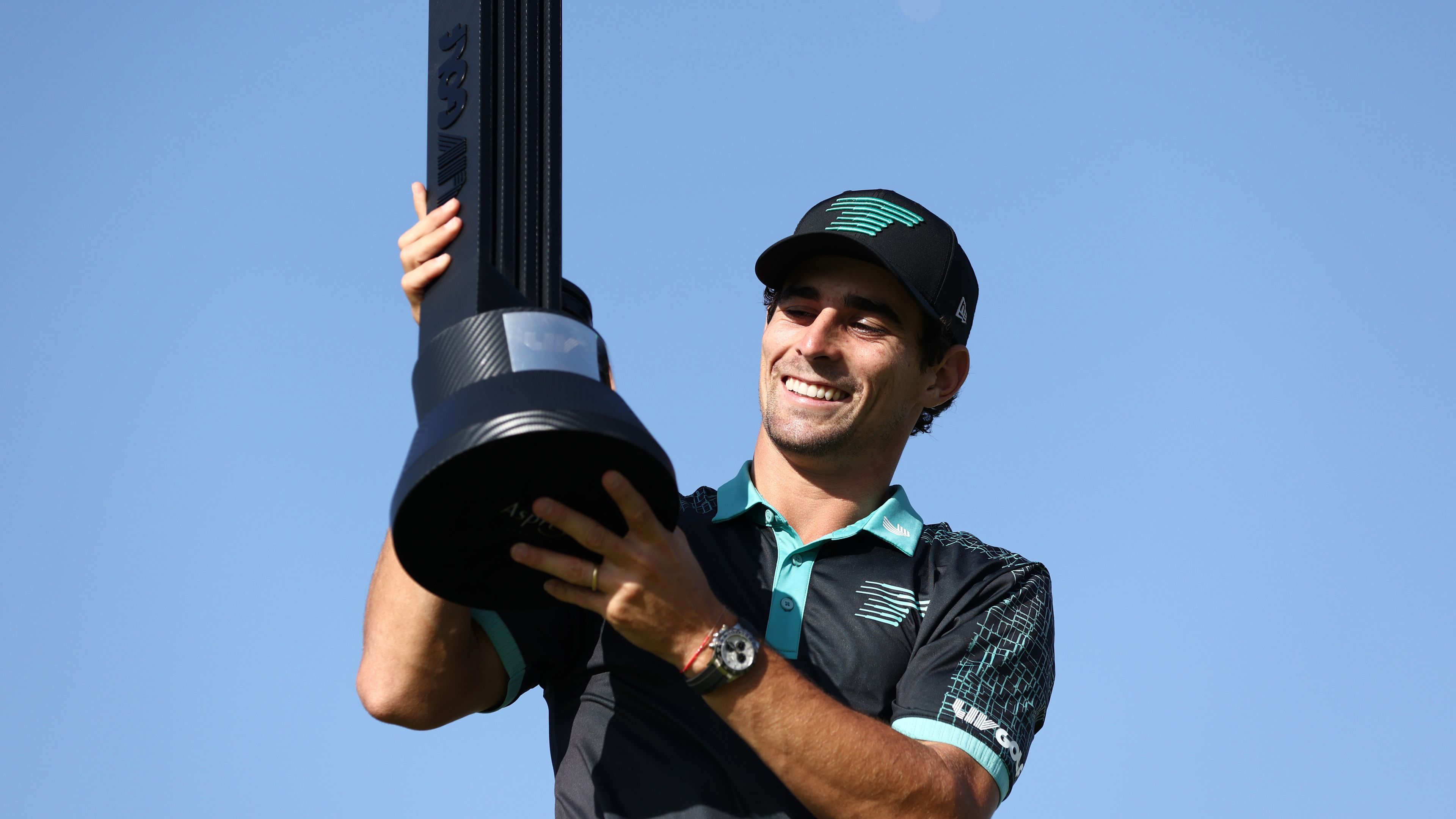 Joaquin Niemann poses for a photo with his trophy after winning the LIV Golf Jeddah Invitational.