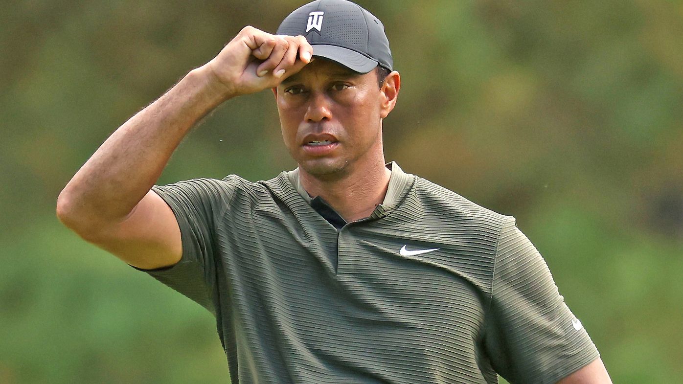 Tiger Woods of the United States reacts to a putt on the first hole