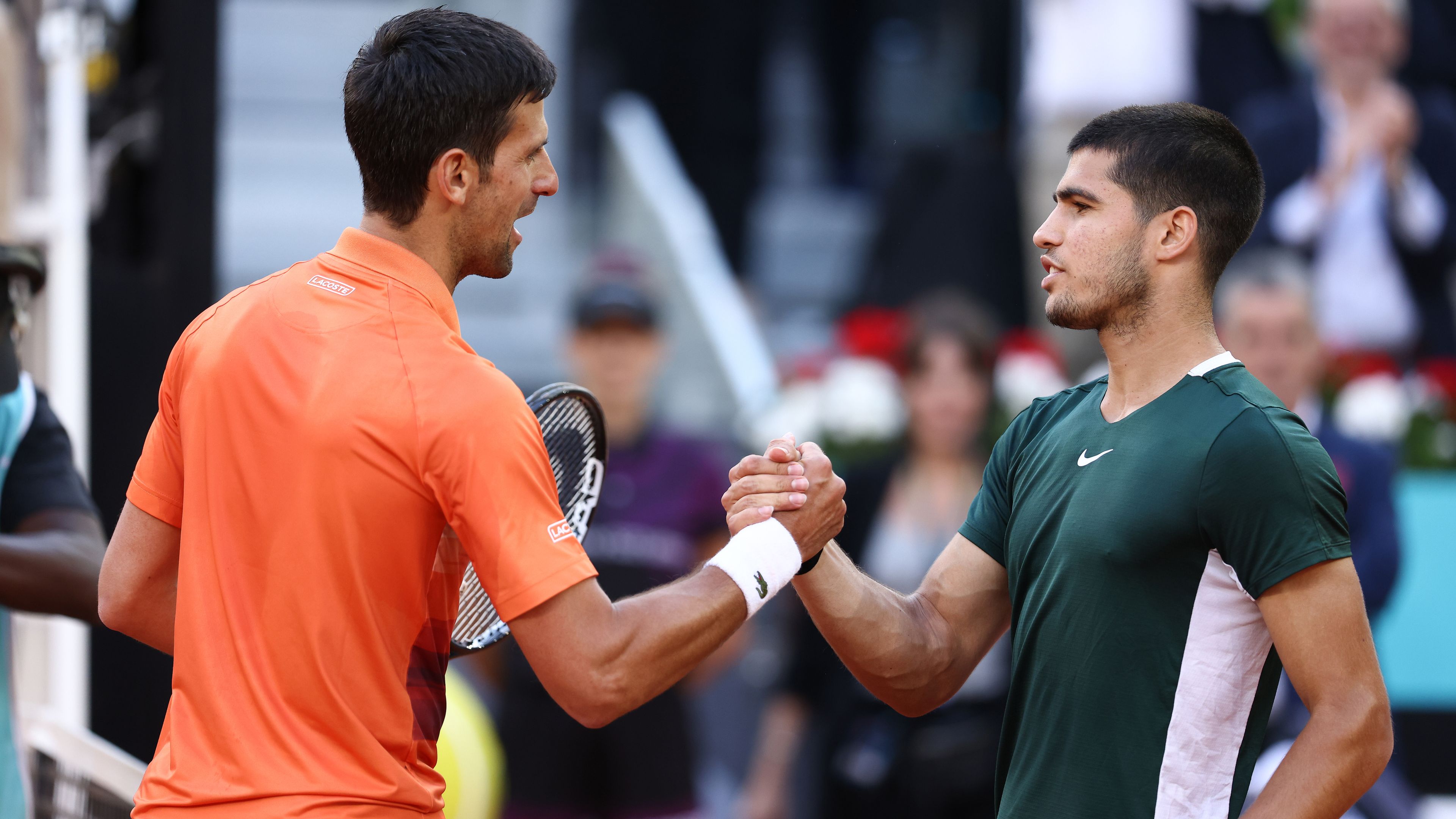 Carlos Alcaraz of Spain greets Novak Djokovic of Serbia.