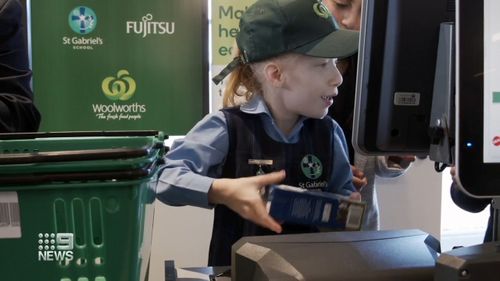Team members from local Woolworths supermarkets help train the students.