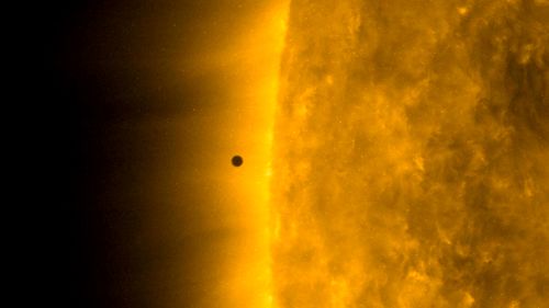 This still image from video issued by NASA's Solar Dynamics Observatory shows Mercury as it passes between Earth and the sun on Monday, November 11, 2019. The solar system's smallest, innermost planet resembles a tiny black dot during the transit.