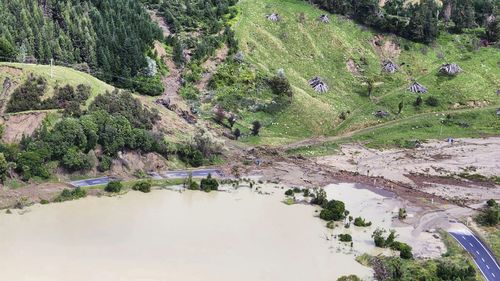 In this image released by the New Zealand Defence Force on Wednesday, Feb. 15, 2023, a road between Napier and Wairoa is washed out by flood water. The New Zealand government declared a national state of emergency Tuesday after Cyclone Gabrielle battered the country's north in what officials described as the nation's most severe weather event in years. (New Zealand Defense Force via AP)