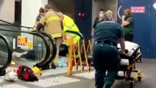 A woman has had to be cut free after becoming caught in an escalator on the Gold Coast, being rushed to hospital after the ordeal. 